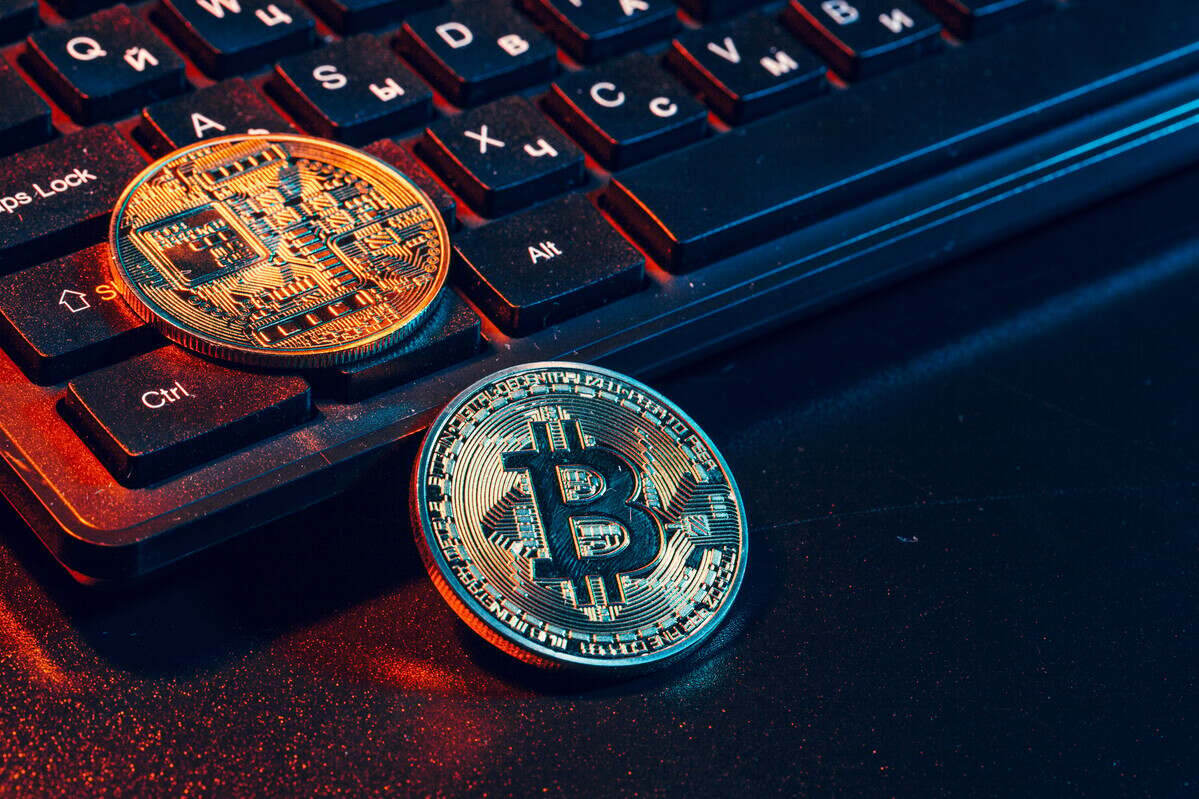 Golden bitcoin coin cryptocurrency on the laptop keyboard