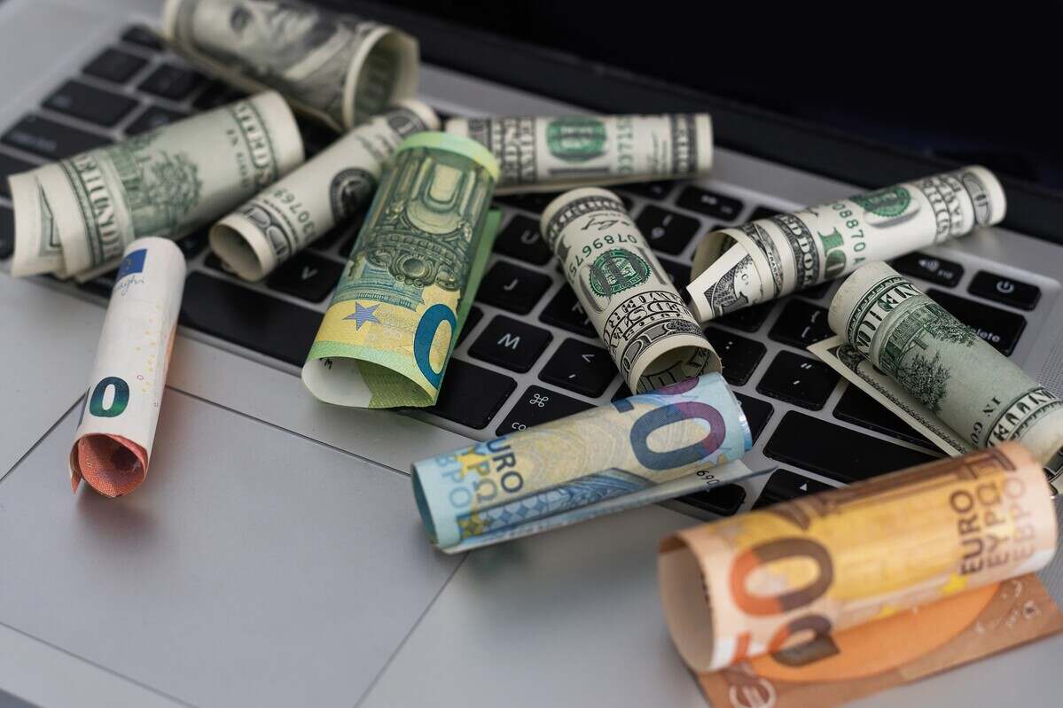 US dollars in closeup on laptop.