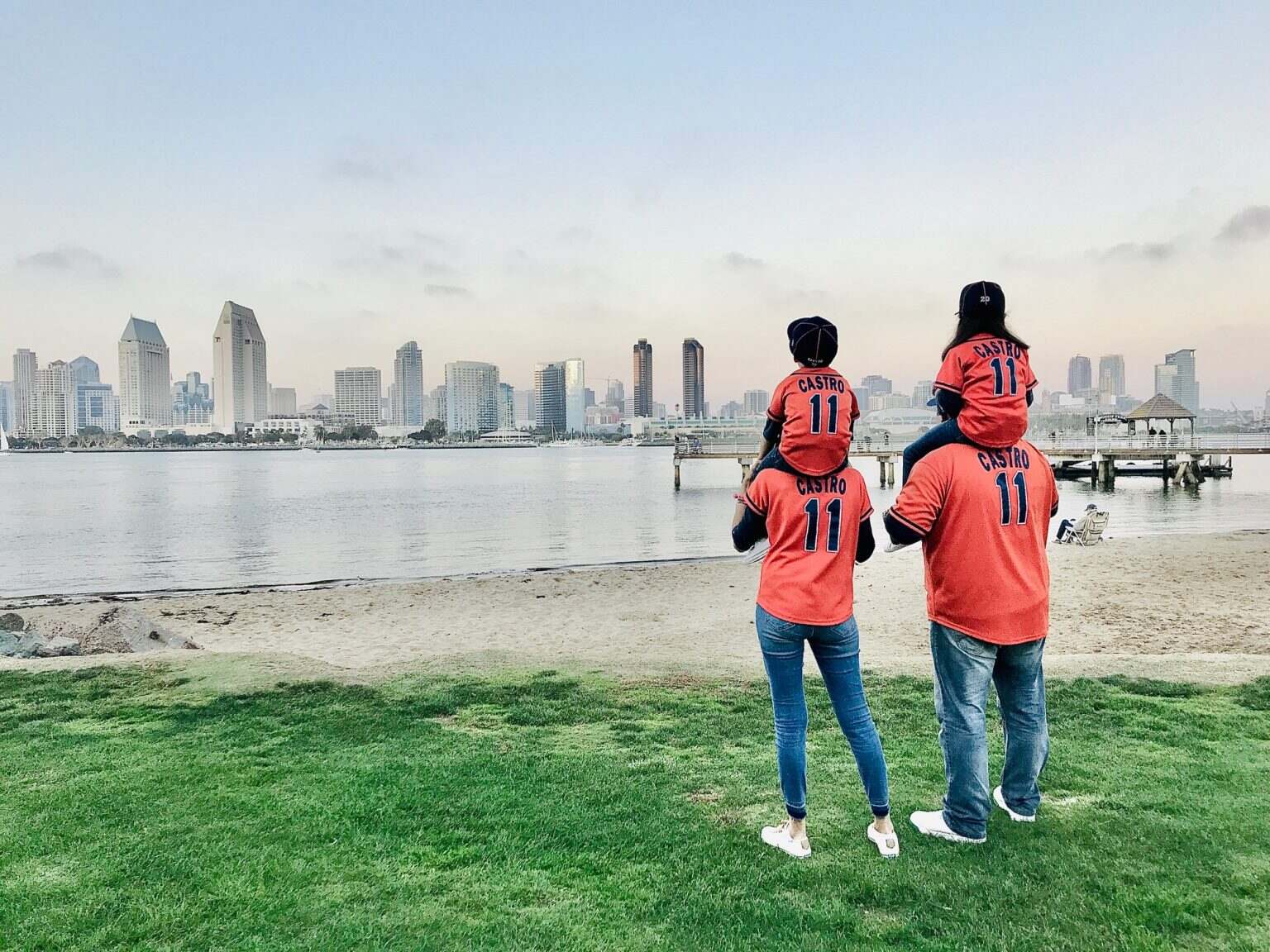 A cute family of Jason Castro and Houston Astros fans standing on the grass