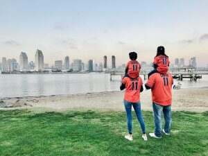 A cute family of Jason Castro and Houston Astros fans standing on the grass