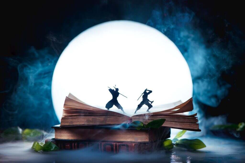 An open book with two ninja warrior silhouettes fighting in full Moon. Reader imagination and