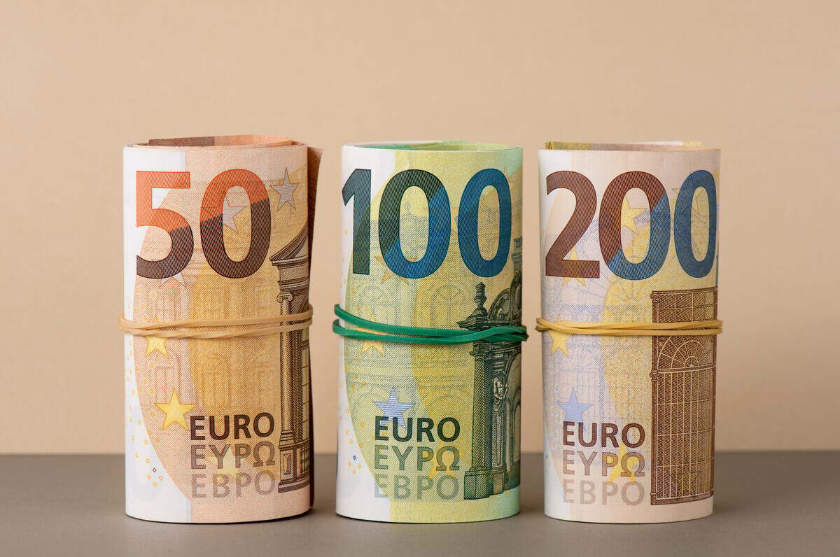 Euro in rolls background. Fifty, one hundred and two hundred euro bills are rolled up.