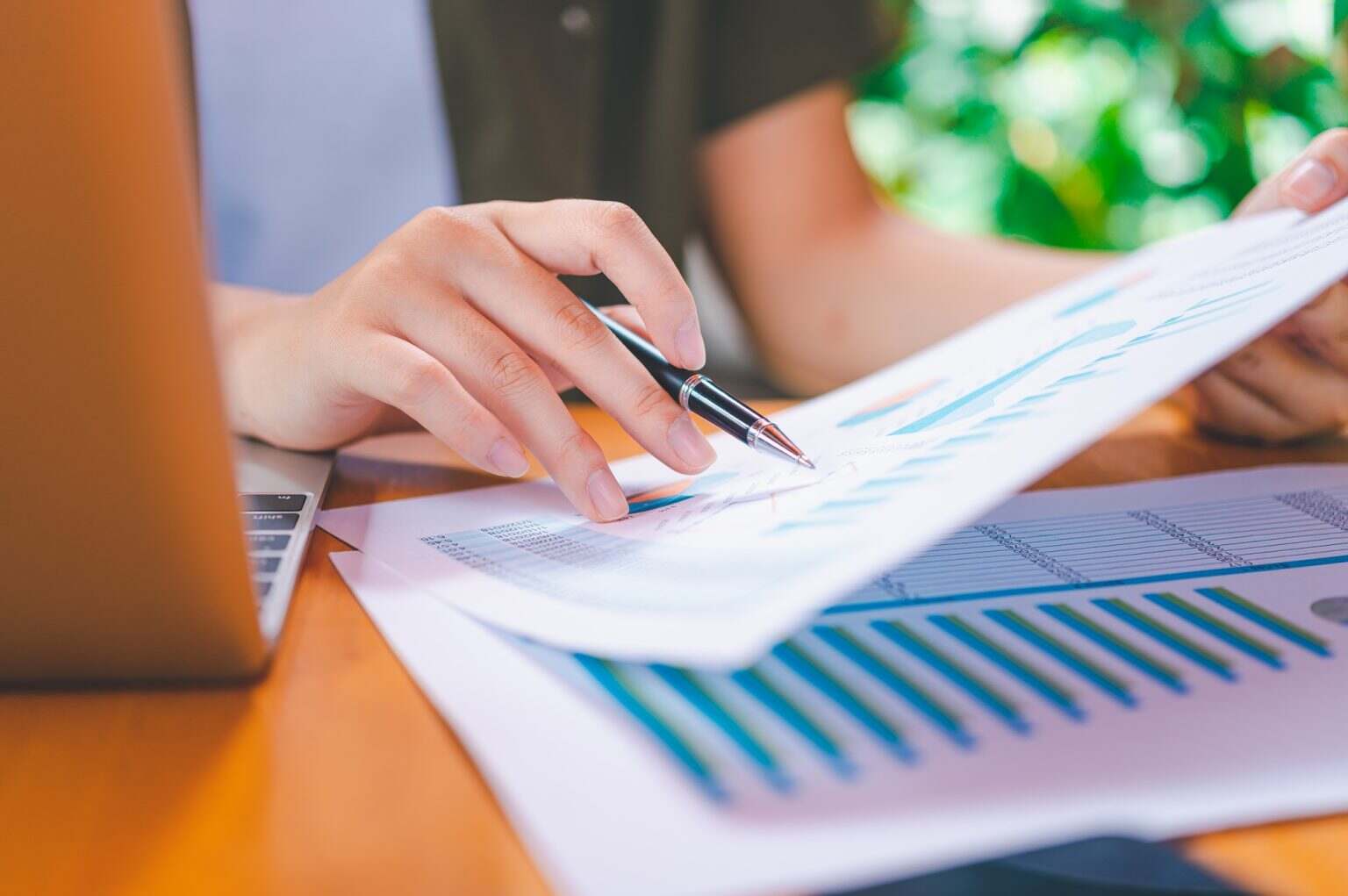 Freelance worker working on documents with graphs.