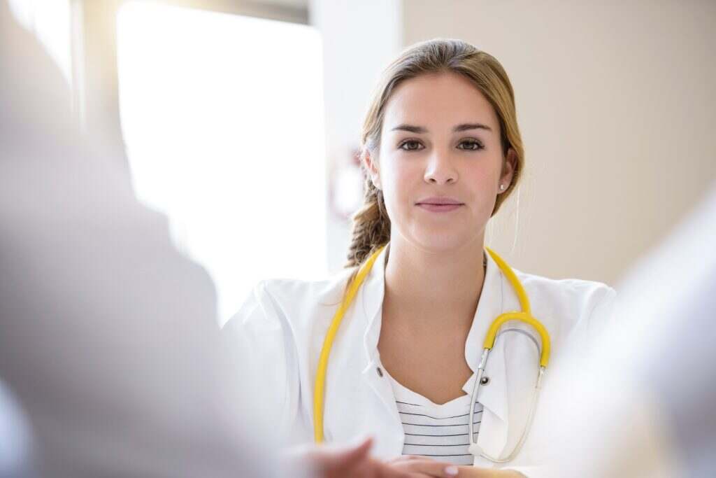 Portrait of female doctor in meeting, differential focus