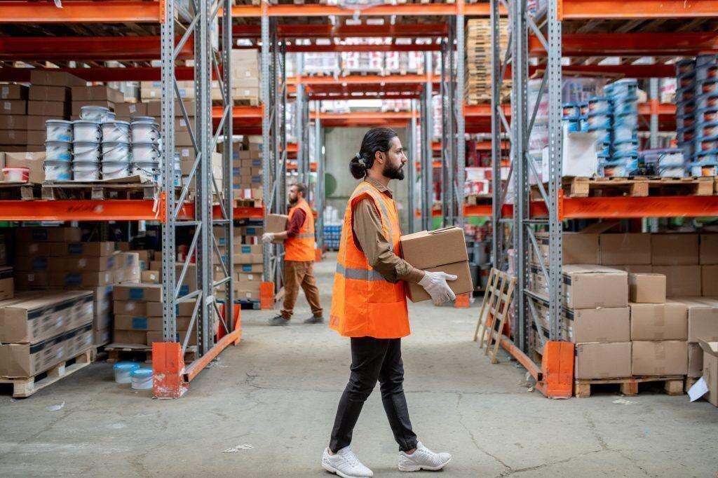 Shipping clerk carrying boxes