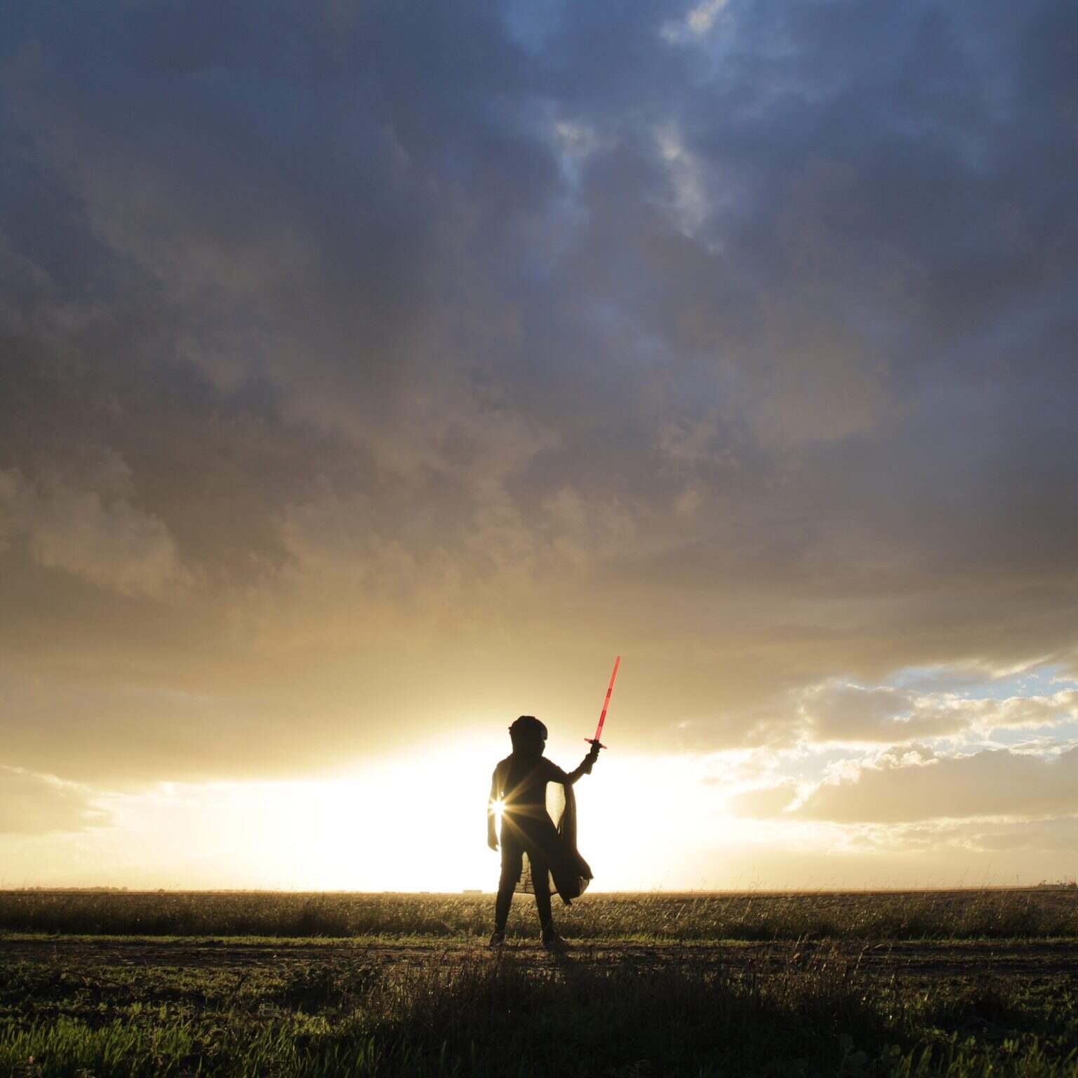 Star Wars. Lightsaber. Minimal person in the storm heavy clouds shining light power