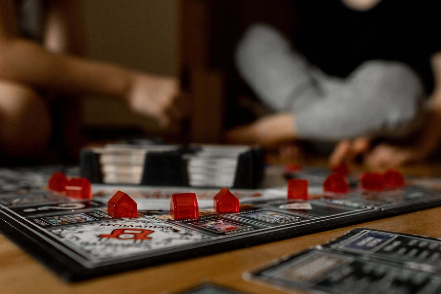 Boys, brothers play a board game. Children play monopoly