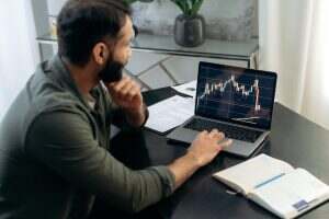 Laptop screen with stock diagrams. Crypto trader investor broker using laptop for cryptocurrency