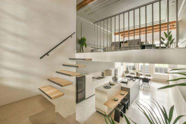 Spacious bright corridor with stairs and entrance to the dining room