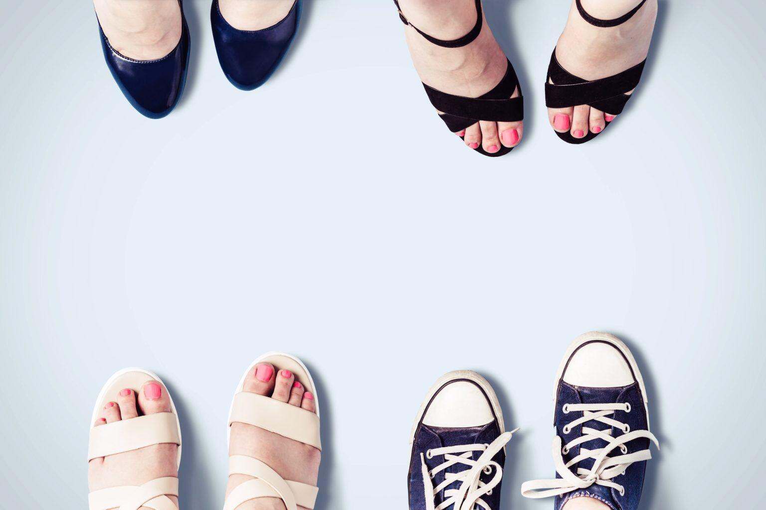 Assorted summer women's shoes. Female feet in sandals, sneakers, shoes.