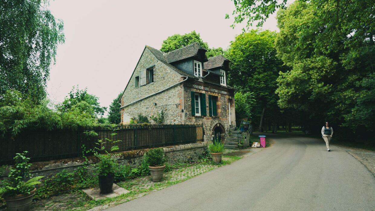 A quaint house sits beside a path.