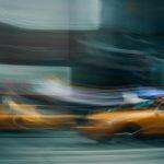 yellow taxi cab on road