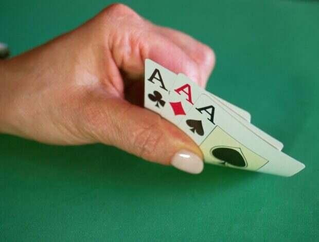 a person holding a playing card in their hand