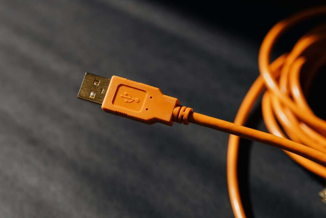 Detailed macro photo of an orange USB cable connector with focus on texture.