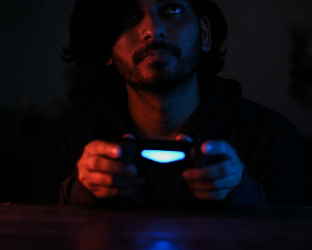 man in black jacket holding black smartphone