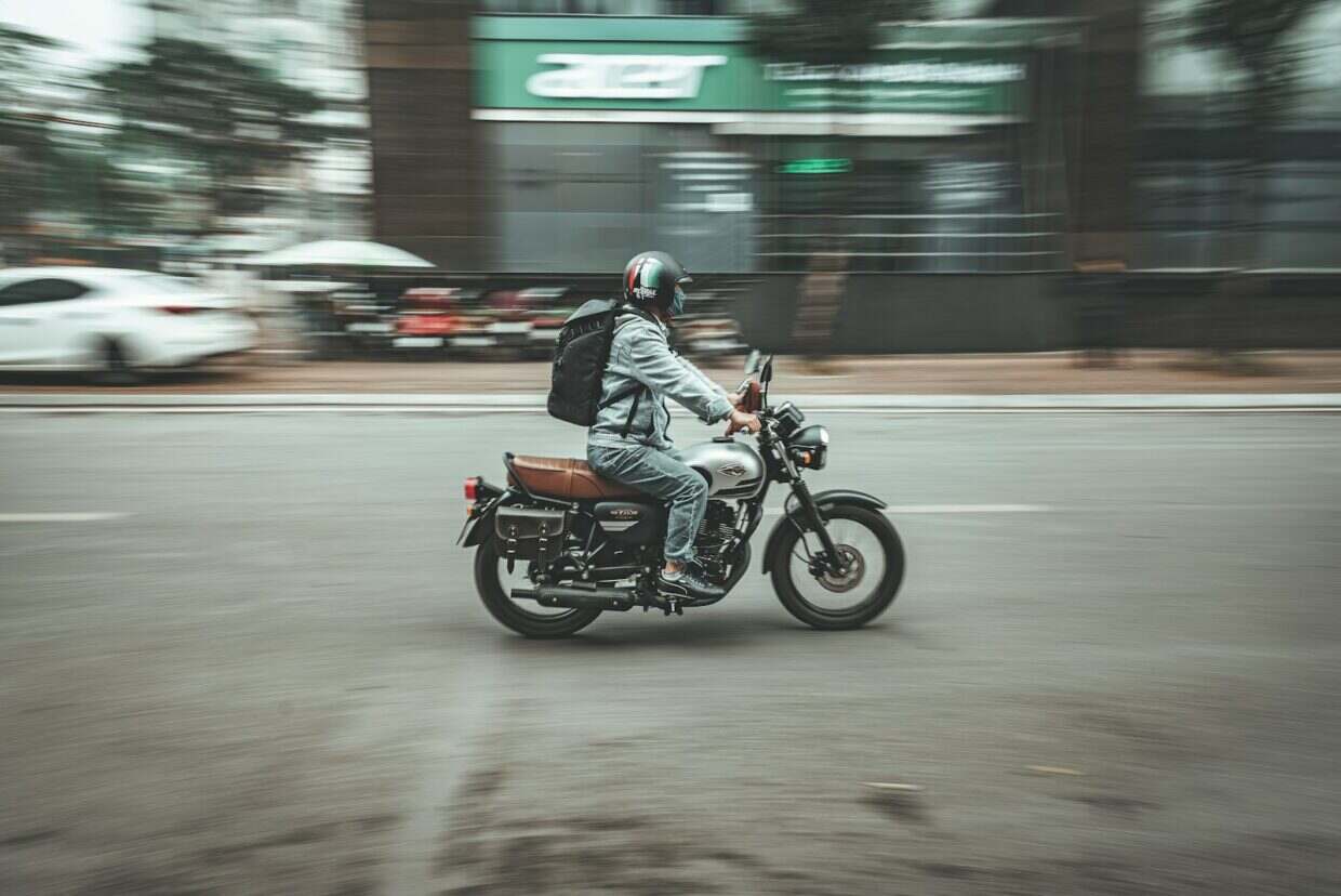 a man riding a motorcycle down a street