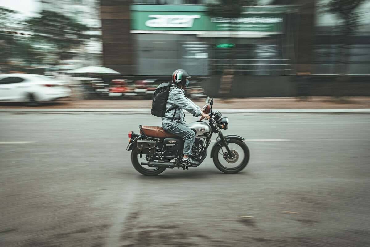 a man riding a motorcycle down a street