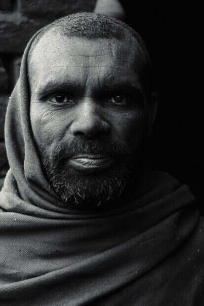 Dramatic black and white portrait of a South Asian man wearing a headscarf in Pakistan.