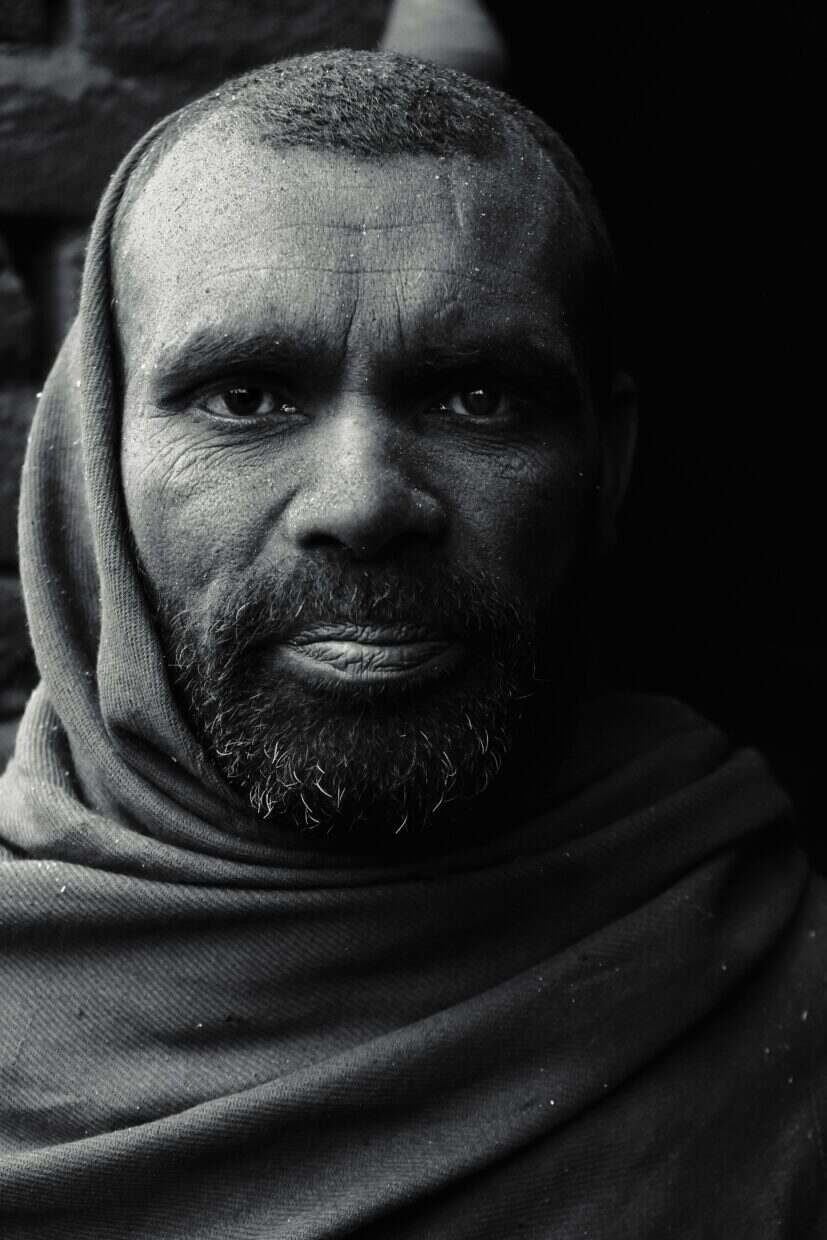 Dramatic black and white portrait of a South Asian man wearing a headscarf in Pakistan.