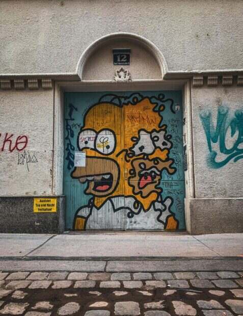 Street art of a popular cartoon character on a Viennese building door, showcasing urban creativity.