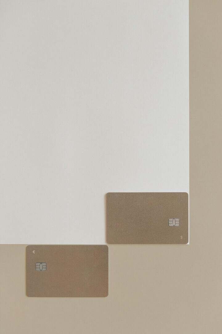 Two blank credit cards placed on a simple neutral background, showcasing modern simplicity.