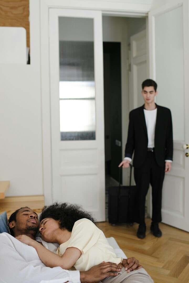 Man discovers unexpected scene in doorway, capturing shock and emotions.