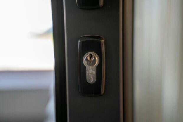 Detailed view of a steel keyhole on a door ensuring security and privacy.