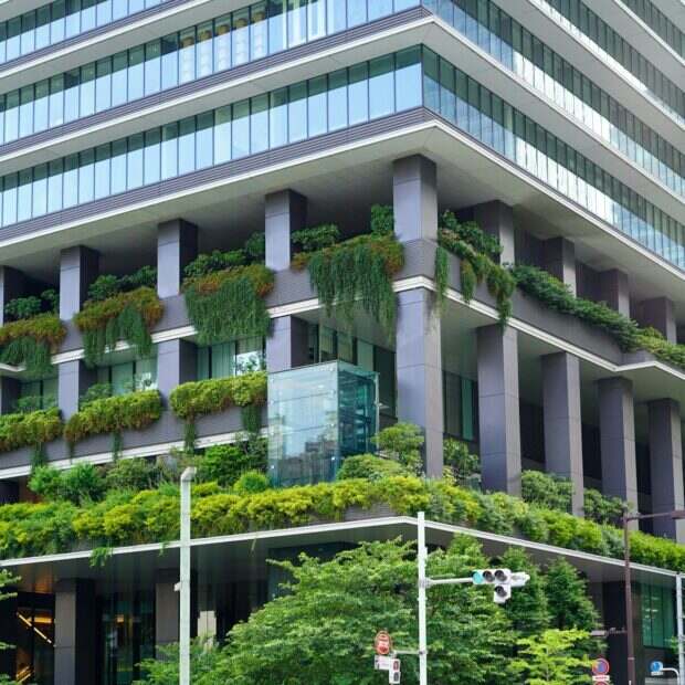 a very tall building with a bunch of plants on it