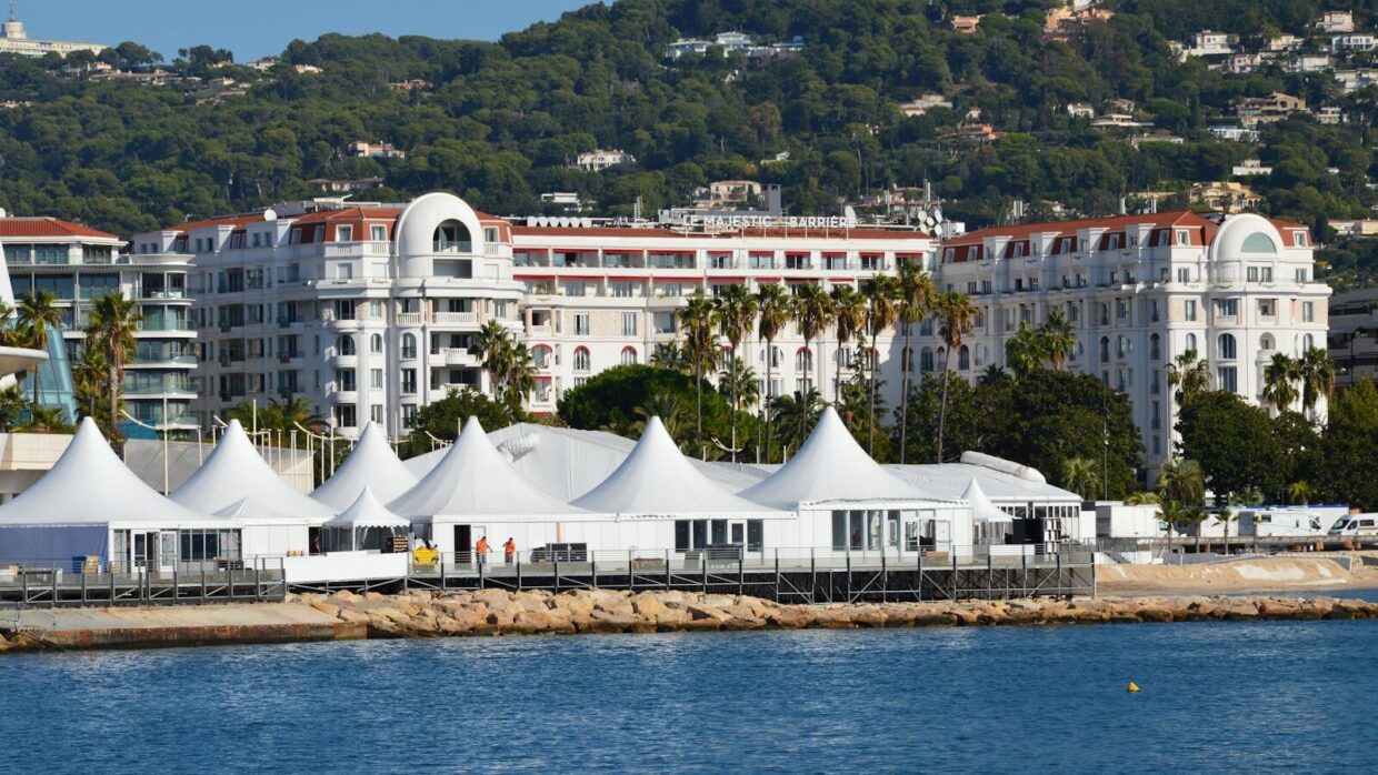 View of luxury hotels and white tents by the seashore in Cannes, France.