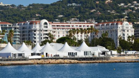 View of luxury hotels and white tents by the seashore in Cannes, France.