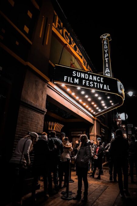 Crowd gathers under the illuminated marquee of the Egyptian Theatre during Sundance Film Festival in Park City.