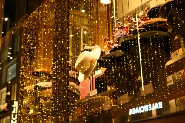 Sparkling golden lights adorn a shop window display.