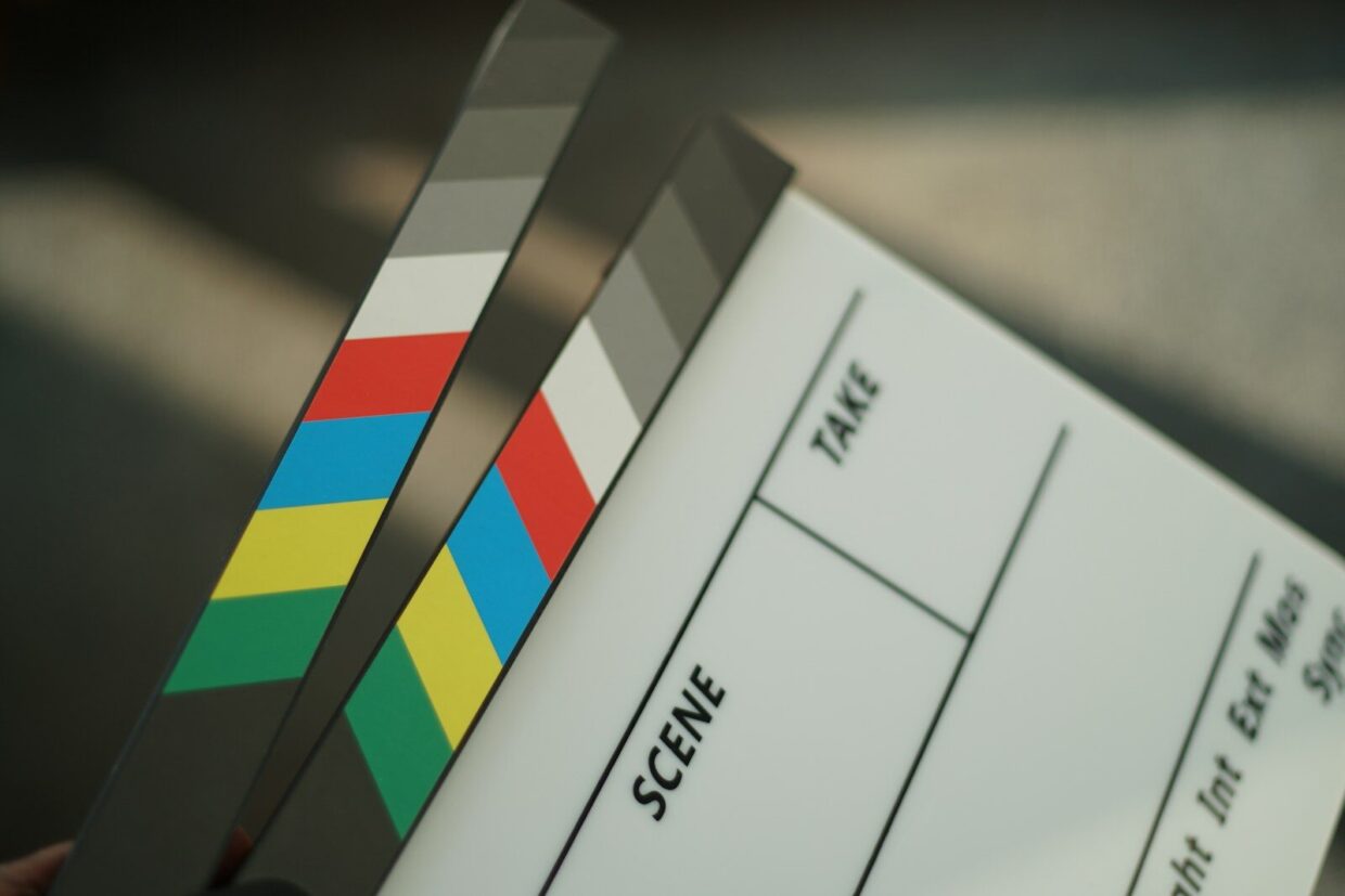 A person holding a movie clapper in their hand