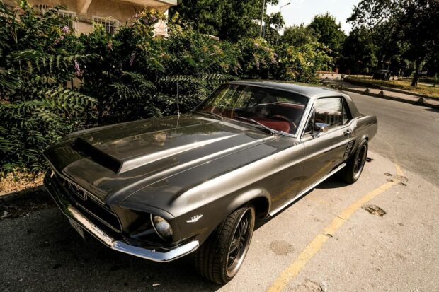 Vintage Ford Mustang parked outdoors, capturing retro style in sunny Istanbul.