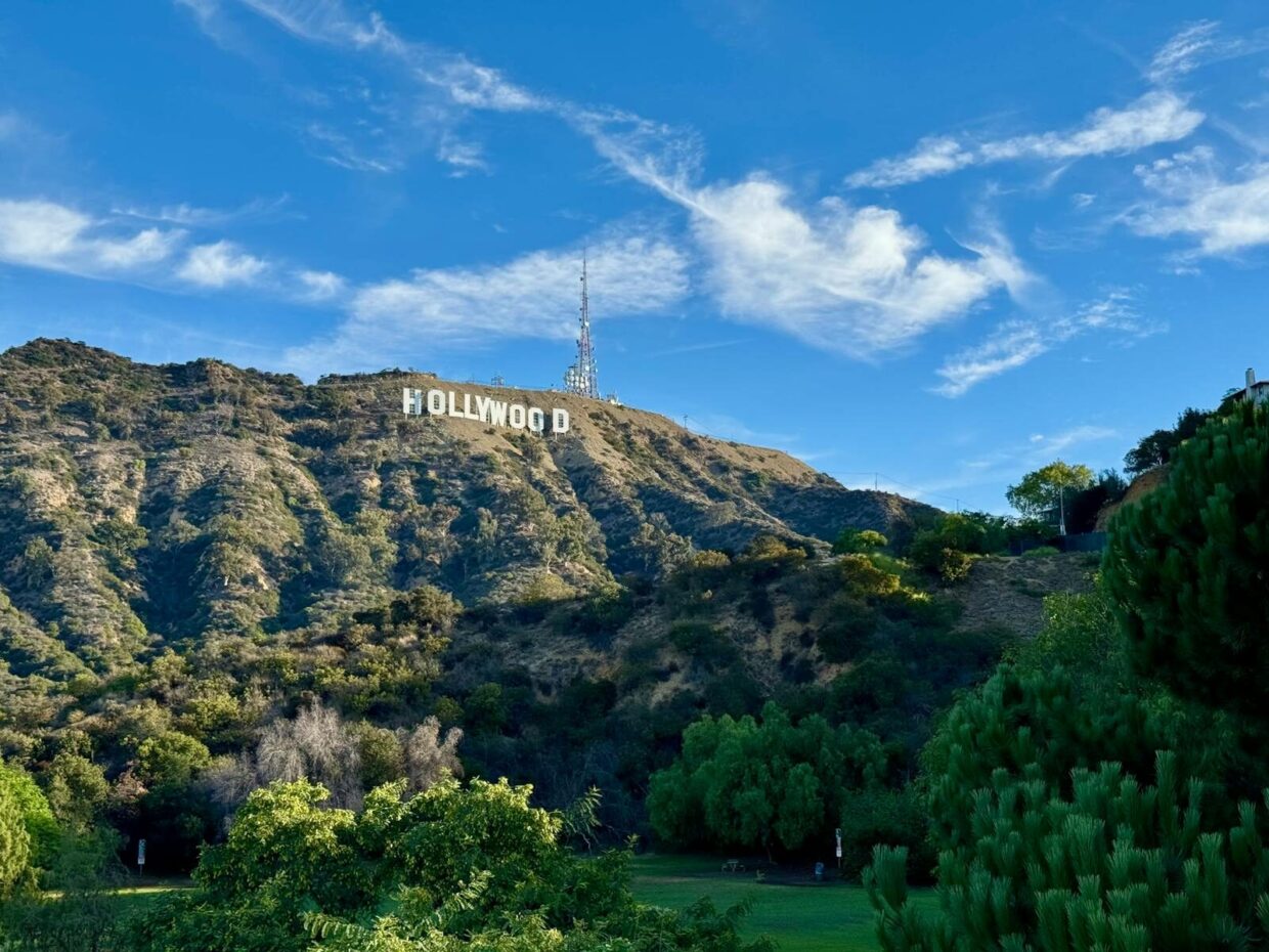 View of the famous Hollywood Sign in Los Angeles, California, showcasing scenic hills and clear skies.