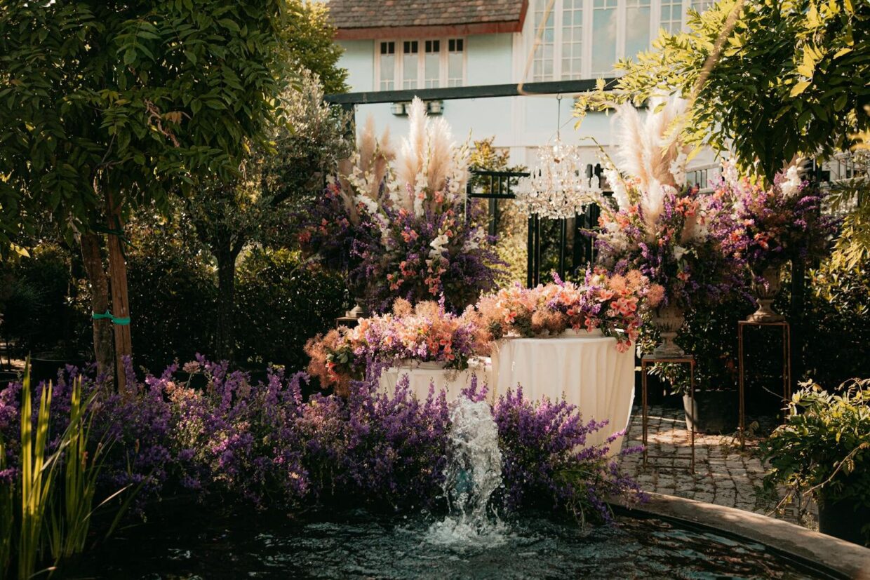 Elegant garden with diverse flowers and a water fountain, ideal for relaxation.