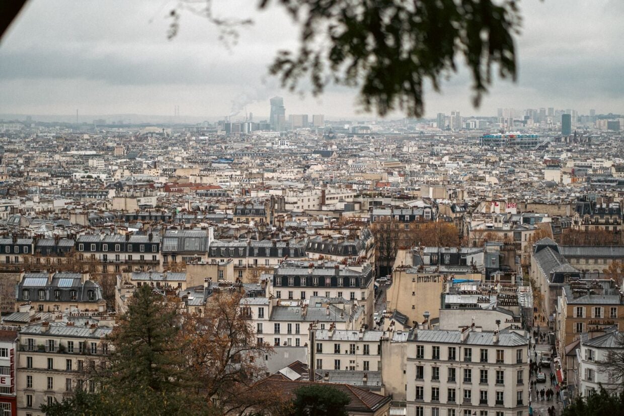 A panoramic view of Paris showcasing classic architecture on a cloudy autumn day.