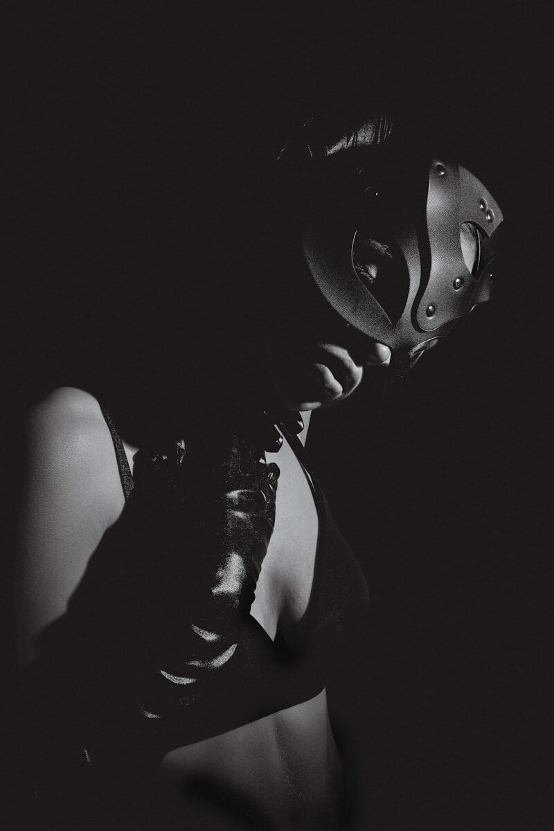 A black and white photo of a woman wearing a mask