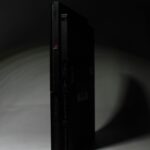 a black video game console in the dark