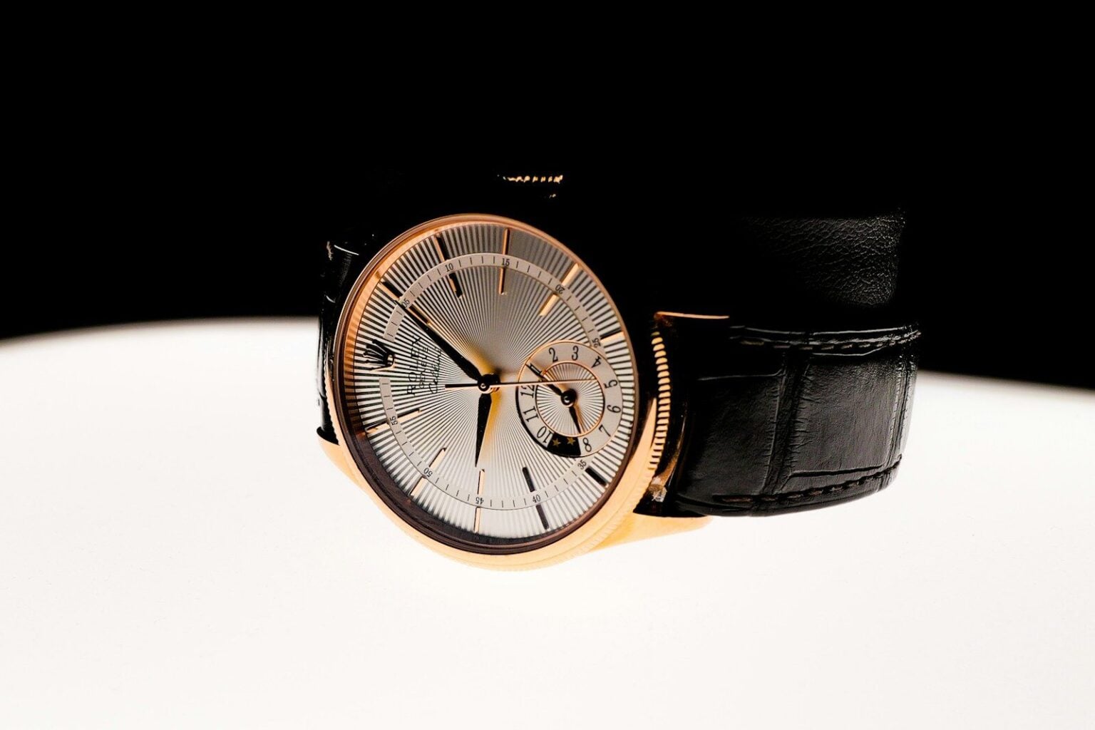 A watch sitting on top of a white table