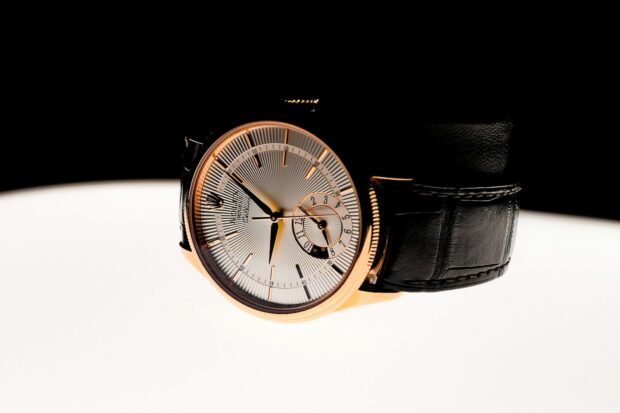 A watch sitting on top of a white table