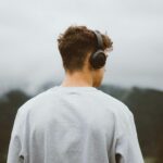 a man with headphones on looking at the mountains