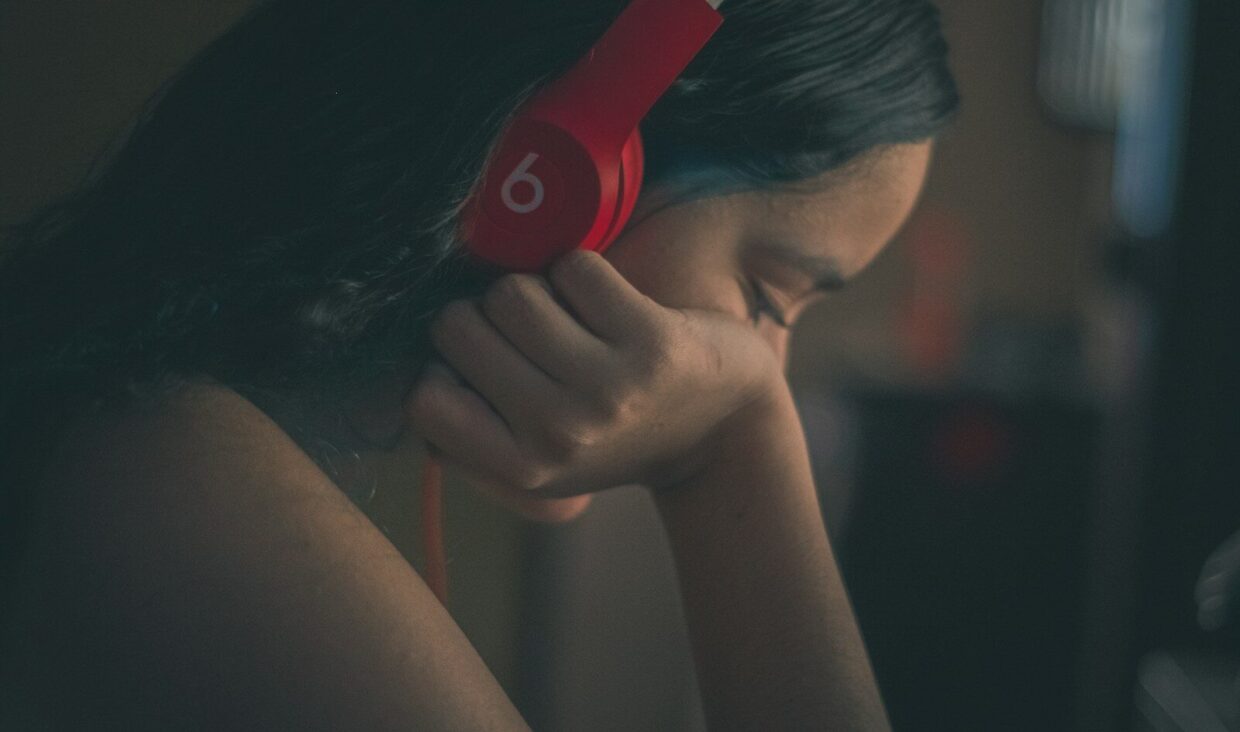 a woman with headphones on her ears