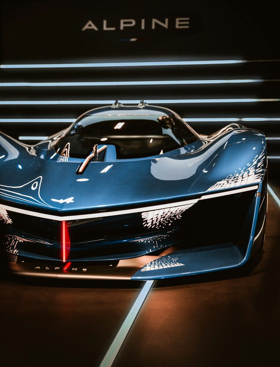 a blue sports car on display at a car show