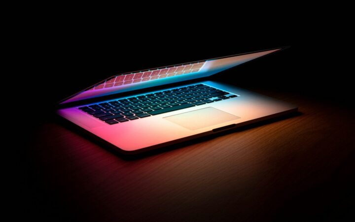 macbook pro on brown wooden table